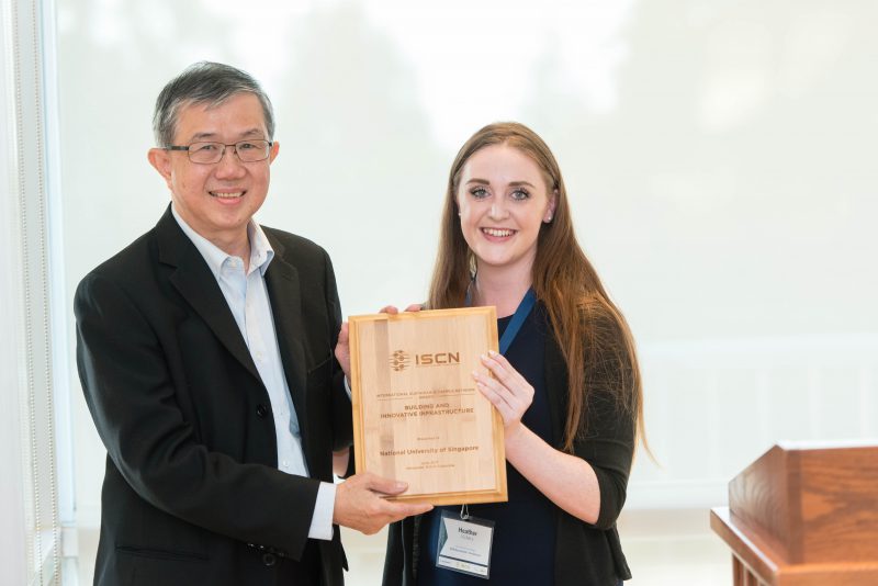 Prof Yong Kwet Yew, Vice President (Campus Infrastructure), receiving the award from Ms Heather Vickery, ISCN Network Relations Manager.