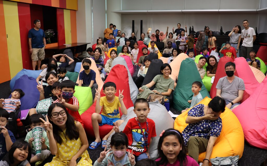 Science communicator BioGirl MJ (in yellow dress seated in front) hosted a fun activity for participants at the end of the movie screening of The Lorax.